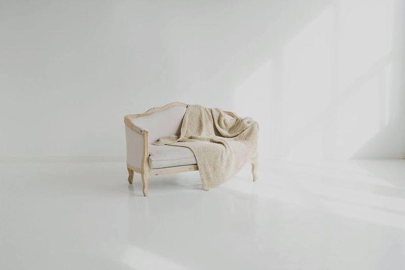 White sofa with folded towel